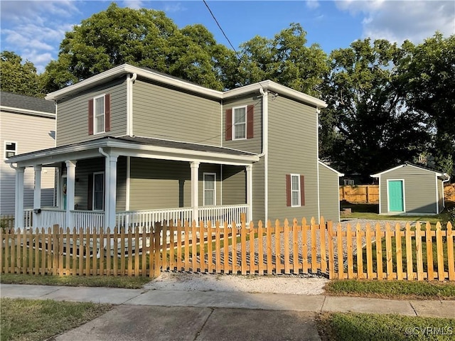 view of front of home featuring a porch and a shed