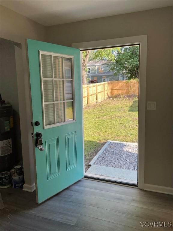 doorway featuring hardwood / wood-style flooring and water heater