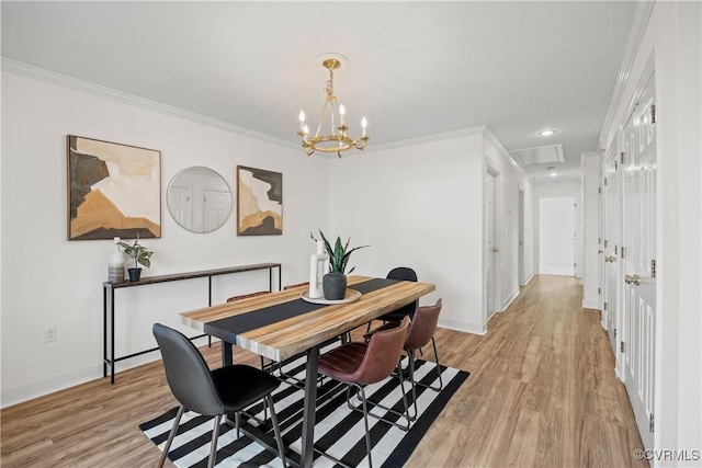 dining space with crown molding and light hardwood / wood-style flooring