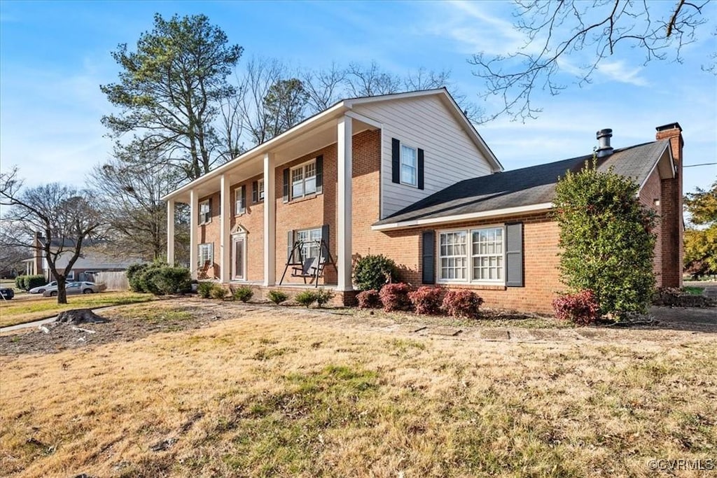 view of home's exterior with a yard