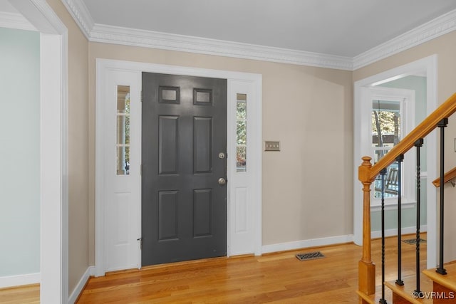 entryway with crown molding and light wood-type flooring