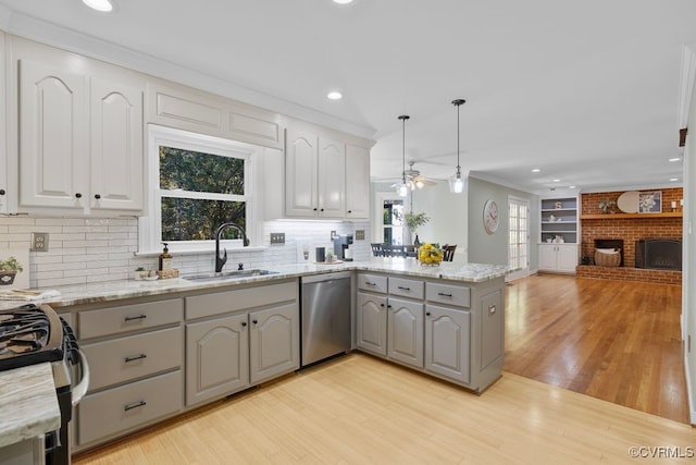 kitchen with sink, decorative light fixtures, gray cabinets, and dishwasher