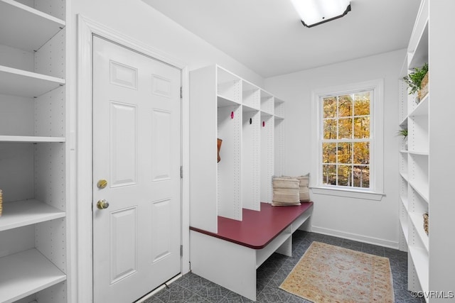 mudroom featuring dark tile patterned flooring