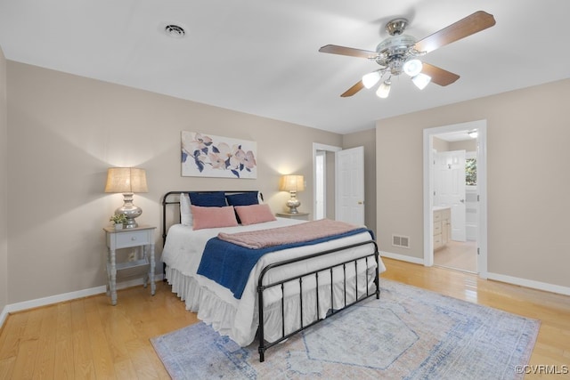 bedroom with ceiling fan, connected bathroom, and light hardwood / wood-style flooring