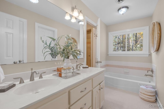 bathroom featuring vanity and a bath