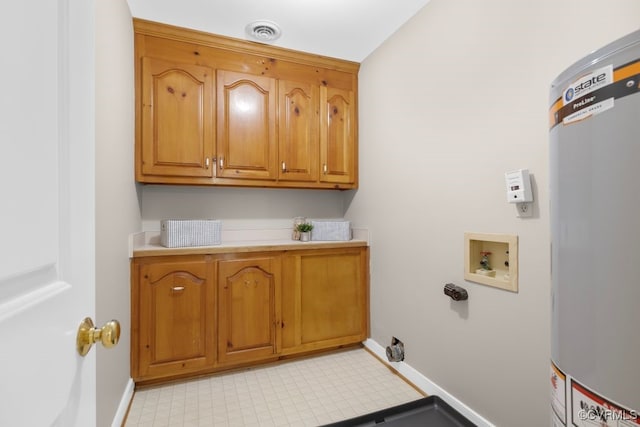 washroom with water heater, washer hookup, and cabinets