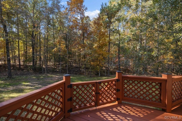 wooden deck featuring a lawn