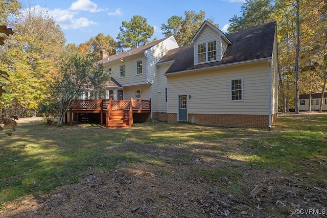 rear view of property featuring a wooden deck and a yard