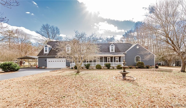 cape cod home with a garage and covered porch