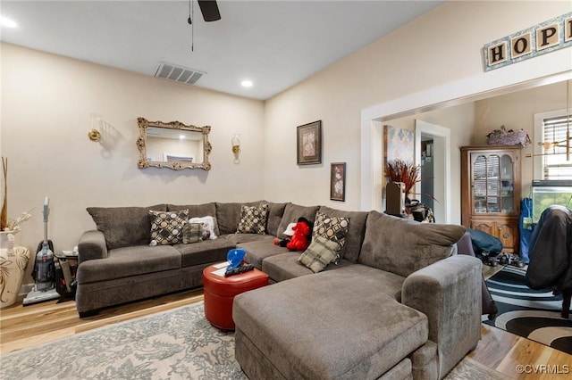 living room with hardwood / wood-style floors and ceiling fan