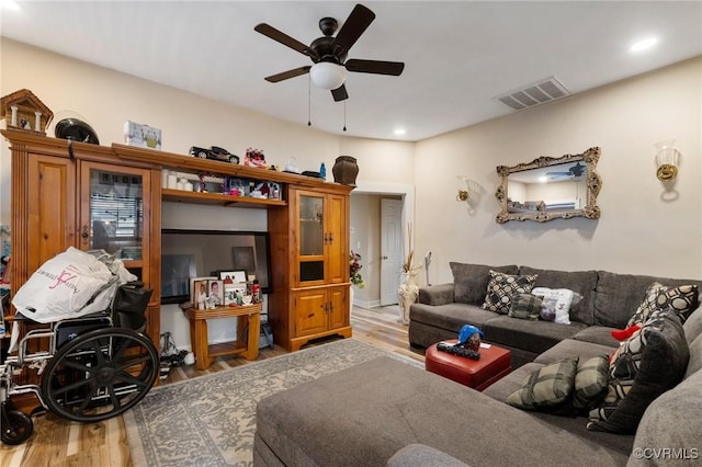 living room with hardwood / wood-style floors and ceiling fan