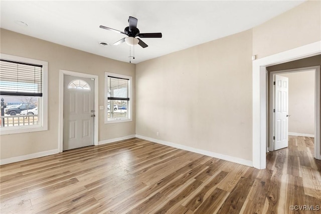 entrance foyer with wood finished floors, a ceiling fan, and baseboards