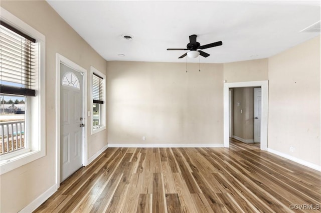 entrance foyer with plenty of natural light, wood finished floors, visible vents, and baseboards