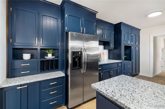 1100 N Ave, Hopewell, VA 23860 - kitchen featuring stainless steel fridge with ice dispenser, open shelves, light wood finished floors, blue cabinetry, and baseboards
