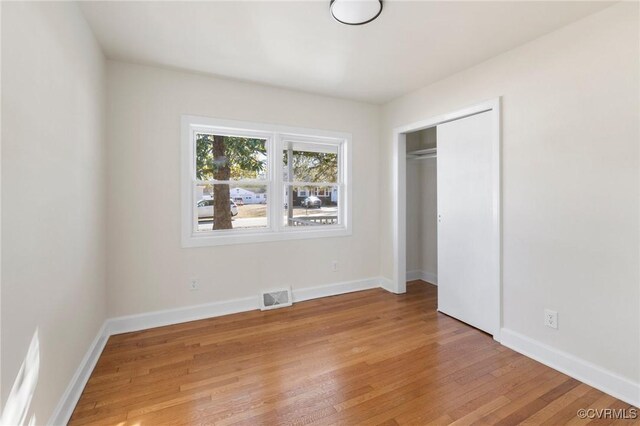 1100 N Ave, Hopewell, VA 23860 - unfurnished bedroom with light wood-style floors, baseboards, and a closet