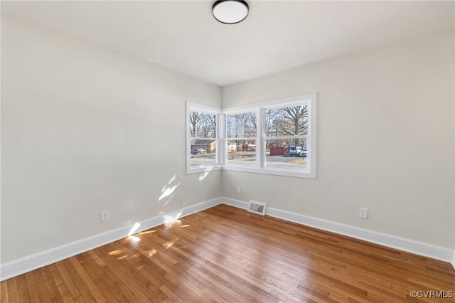 spare room featuring hardwood / wood-style flooring