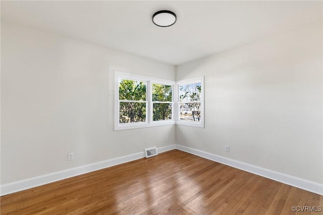 spare room with hardwood / wood-style floors