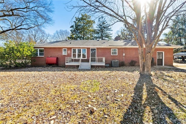 rear view of house with cooling unit and a deck