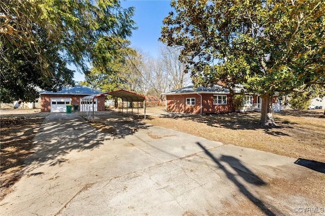 ranch-style house featuring a carport and a garage