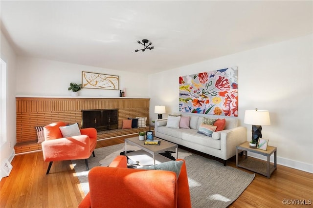 1100 N Ave, Hopewell, VA 23860 - living area with wood finished floors, a brick fireplace, and baseboards