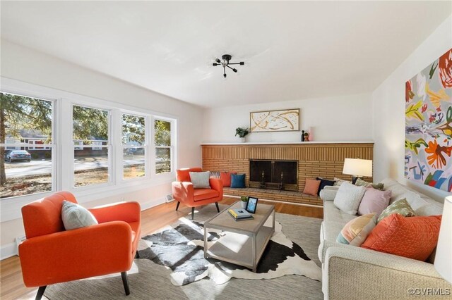 1100 N Ave, Hopewell, VA 23860 - living area featuring wood finished floors, a brick fireplace, and baseboards