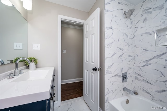 bathroom with vanity and tiled shower / bath