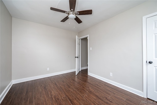 empty room with dark wood-type flooring and ceiling fan