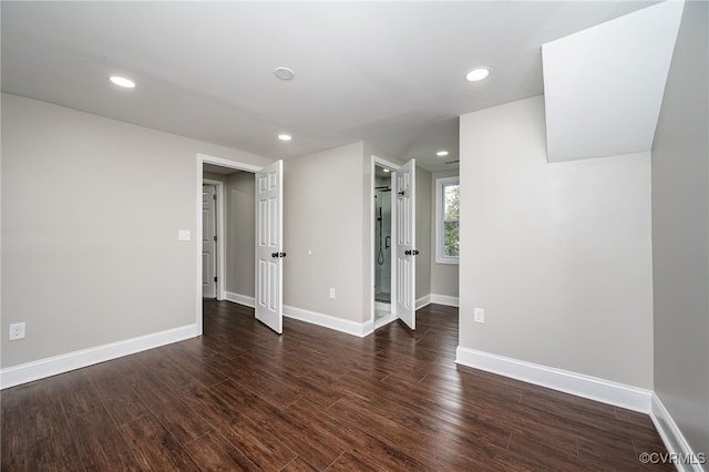 unfurnished room with dark wood-type flooring