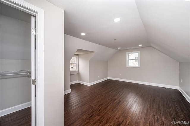 additional living space with lofted ceiling and dark hardwood / wood-style floors