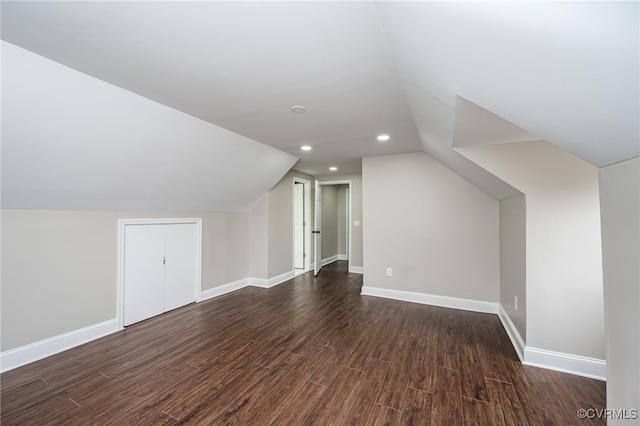 bonus room with lofted ceiling and dark hardwood / wood-style floors