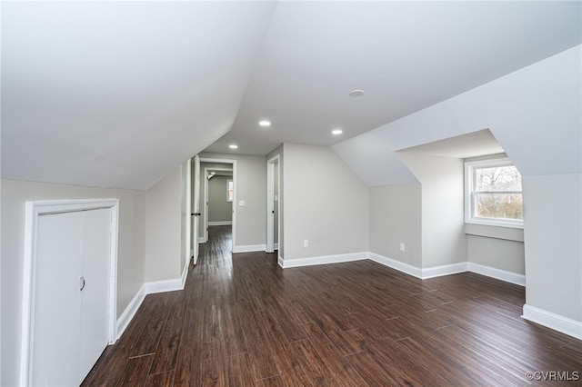 bonus room featuring lofted ceiling and dark hardwood / wood-style floors