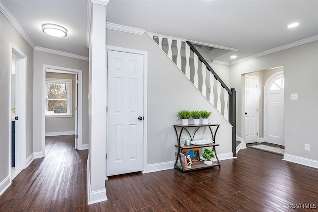 entrance foyer featuring ornamental molding and dark hardwood / wood-style floors