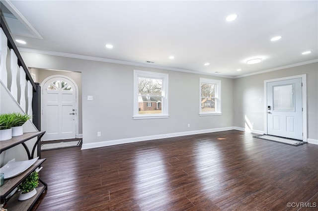 entryway with ornamental molding and dark hardwood / wood-style floors