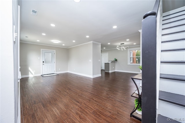 unfurnished living room with crown molding and dark hardwood / wood-style flooring