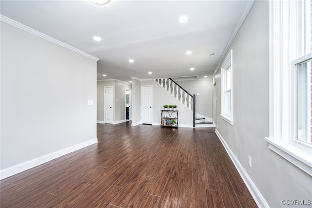 unfurnished living room featuring dark wood-type flooring and crown molding