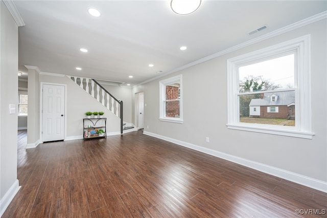 unfurnished living room featuring ornamental molding and dark hardwood / wood-style floors