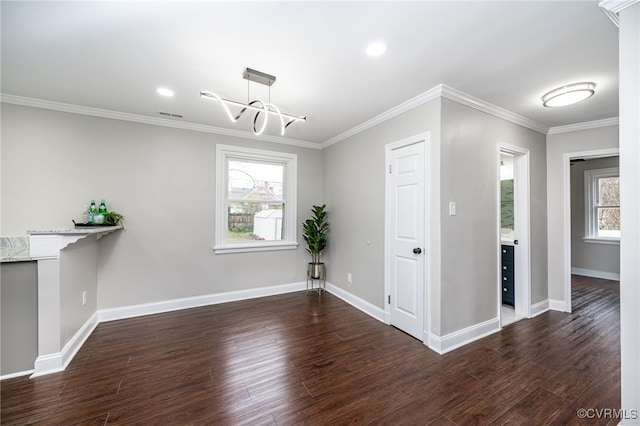 unfurnished dining area with dark hardwood / wood-style flooring, a notable chandelier, and ornamental molding