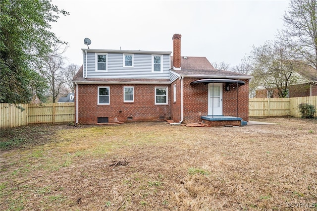 rear view of property featuring central AC unit and a lawn