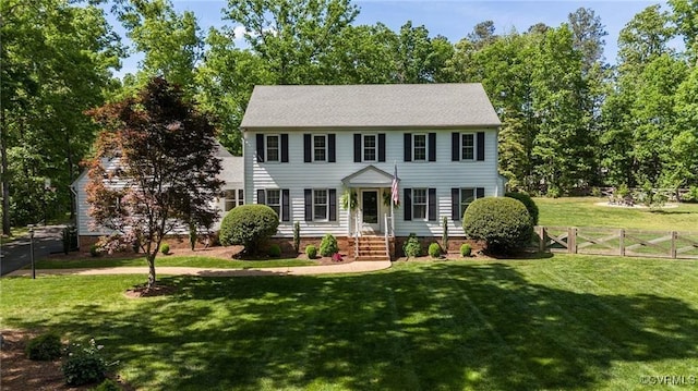 colonial inspired home with a front yard