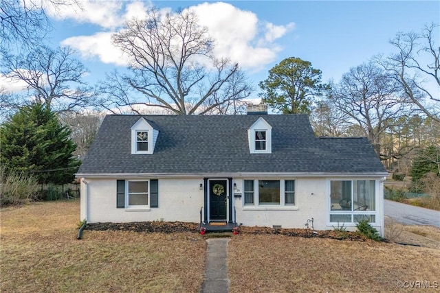 cape cod-style house with a front lawn