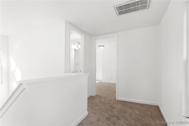 hallway with carpet floors