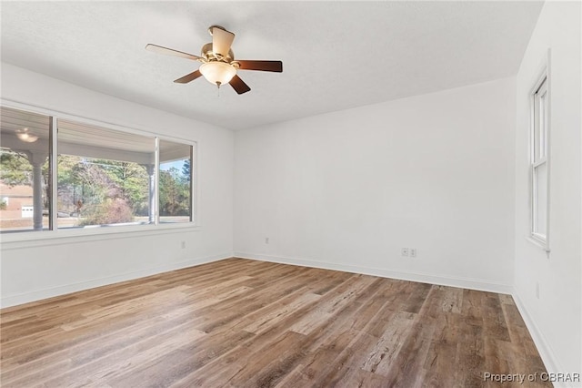 spare room with ceiling fan and light hardwood / wood-style floors