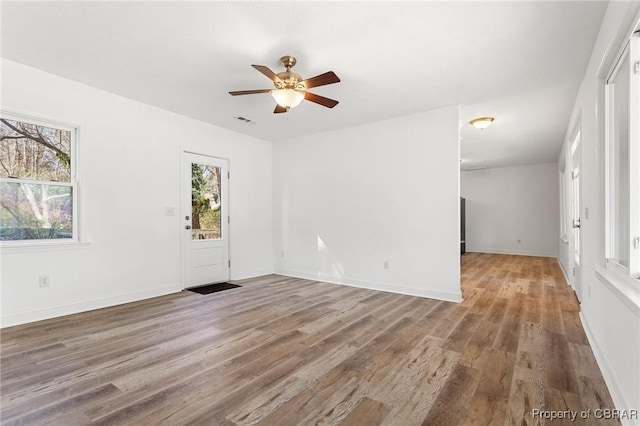 empty room featuring wood-type flooring and ceiling fan