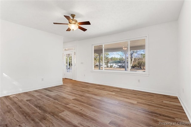 unfurnished room featuring ceiling fan and wood-type flooring