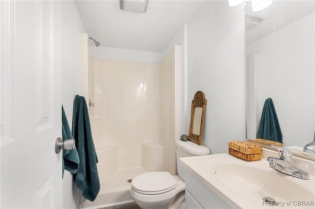 bathroom featuring vanity, toilet, and walk in shower