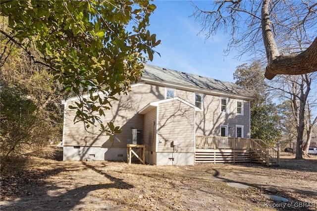 rear view of house with a wooden deck