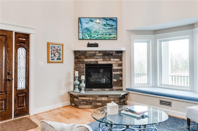 living room with hardwood / wood-style flooring and a fireplace