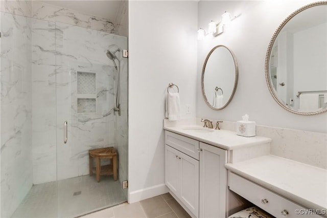 bathroom with a shower with door, vanity, and tile patterned flooring