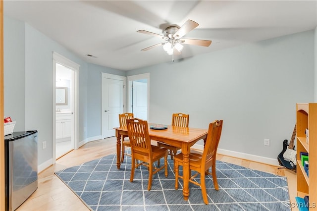 dining room with hardwood / wood-style floors and ceiling fan