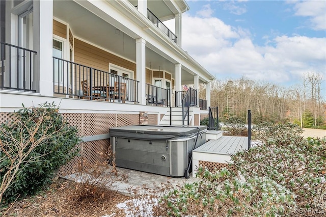 view of side of property featuring a hot tub